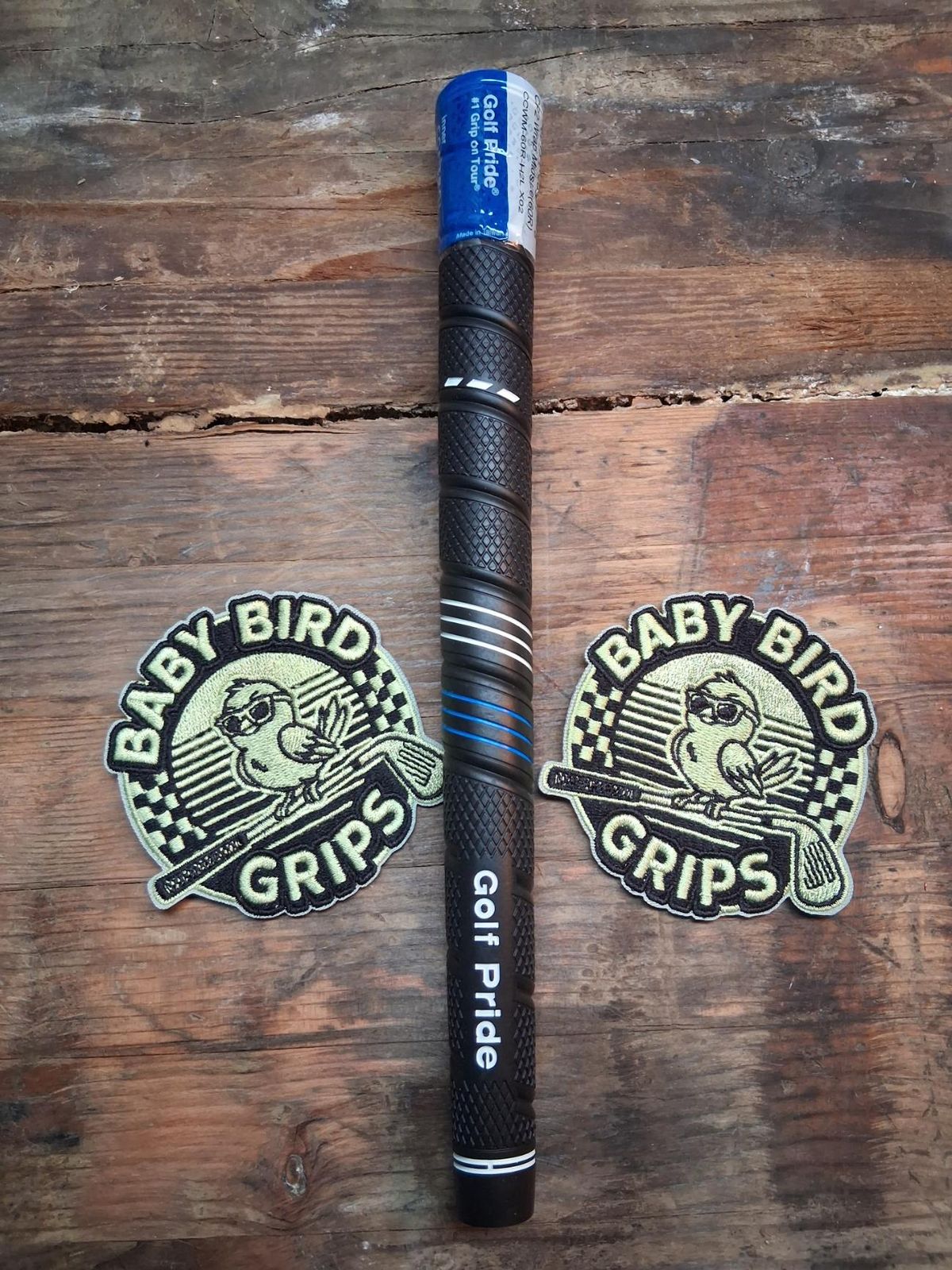 A black Golf Pride CP2 Wrap with blue accent lines and a blue cap