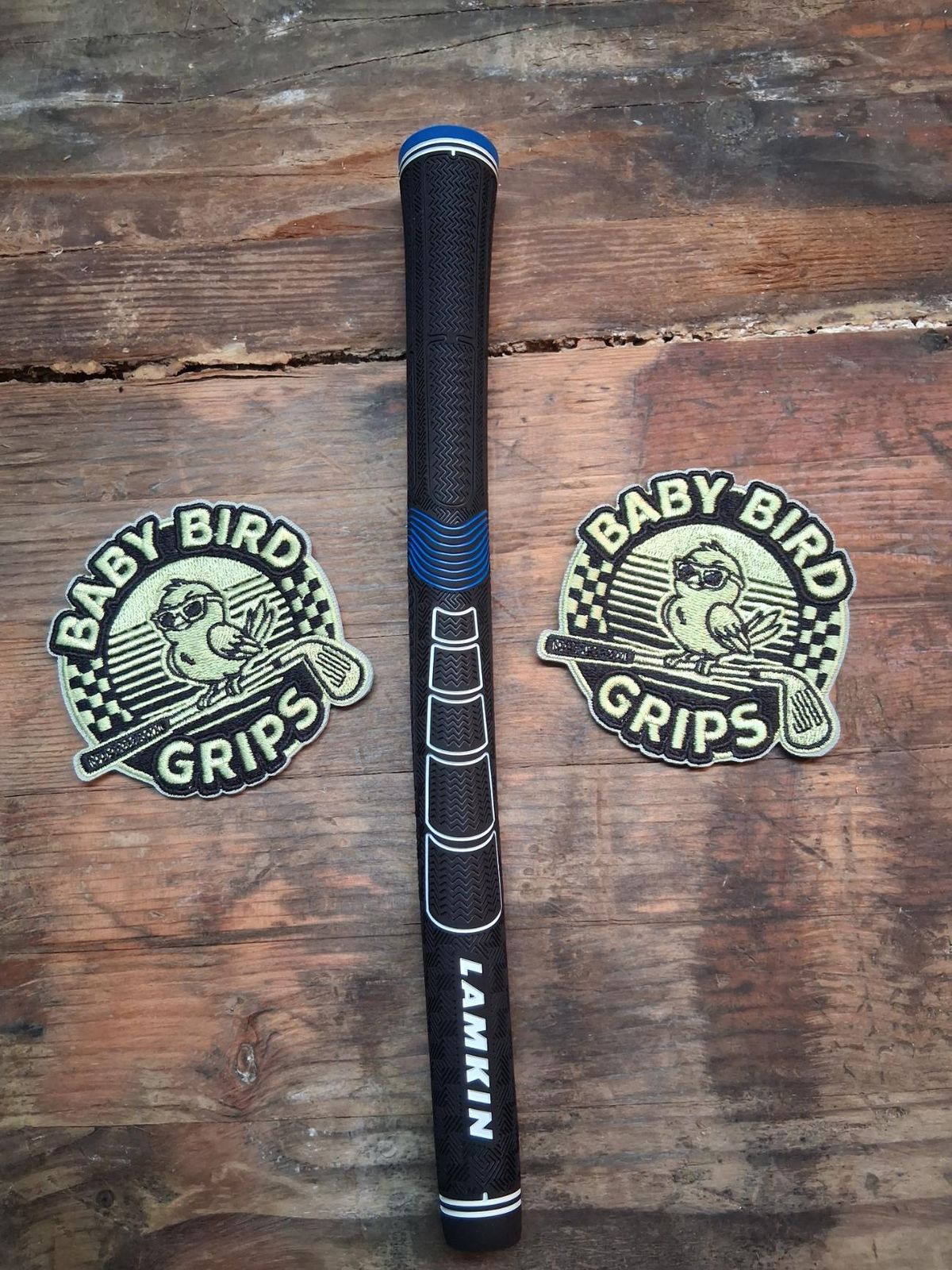 A black Lamkin Sonar grip with a blue cap and a blue wave